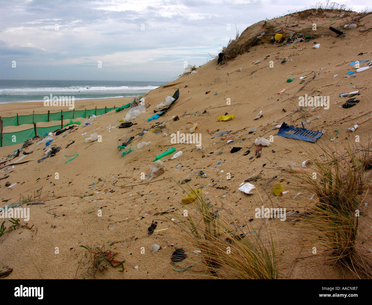 trash rubbish on dunes at the beach of Atlantic ocean in France Stock Photo