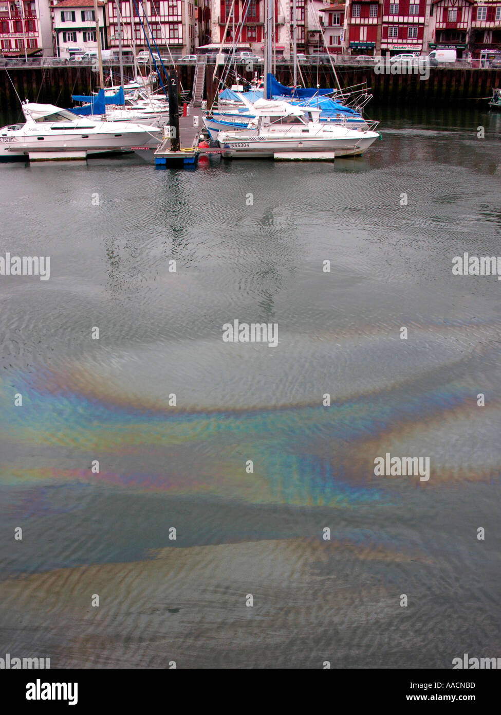 oil swimming on water at the fishing port at a rainy day in St Jean de Luz and in Ciboure Pyrenees Atlantiques France Stock Photo