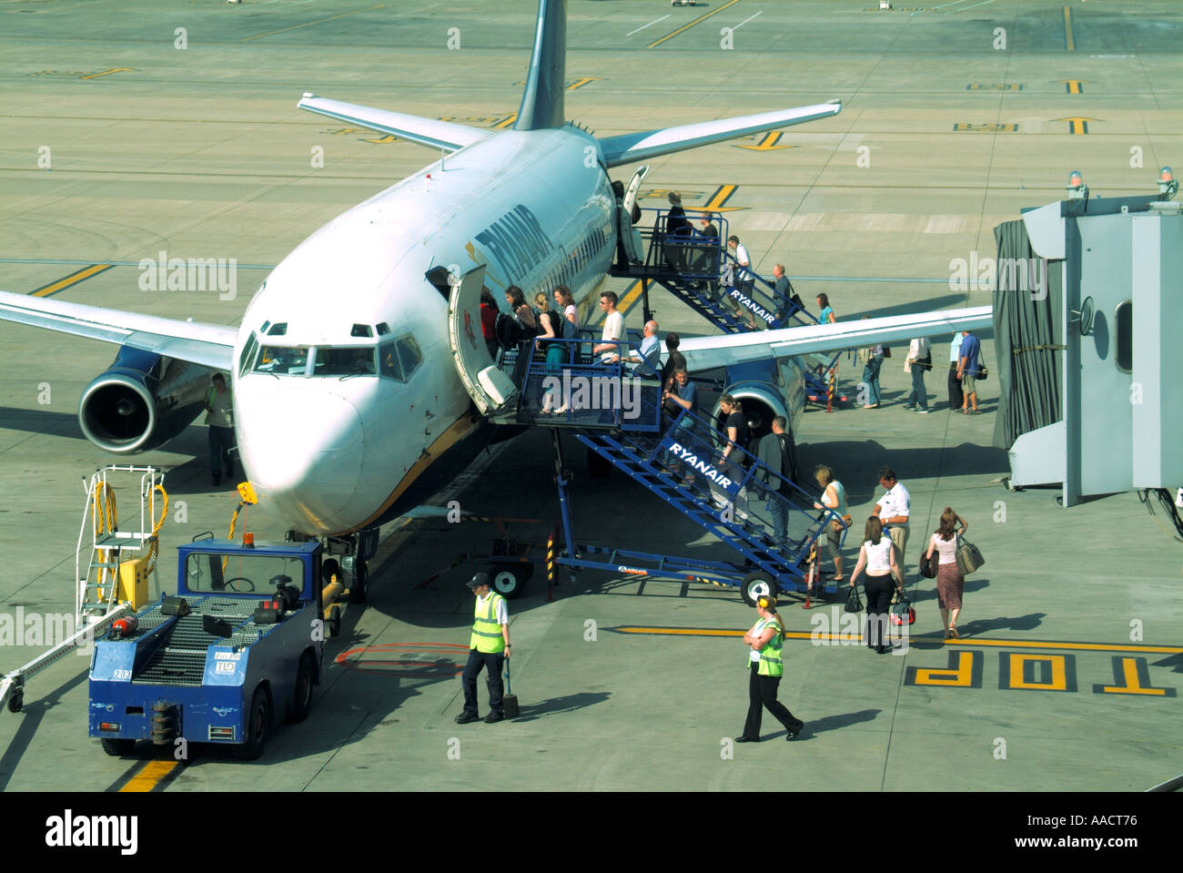 London Stansted Airport view from above Ryanair plane & people boarding from steps avoiding use of expensive unused ramp on right Essex England UK Stock Photo