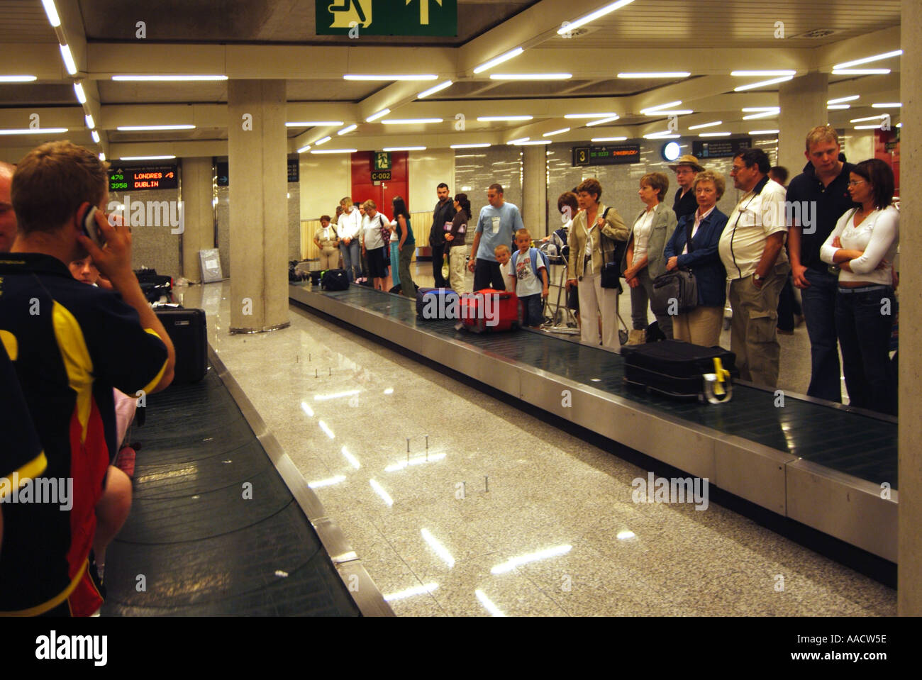 Palma airport luggage carousel passengers waiting to retrieve suitcases Stock Photo