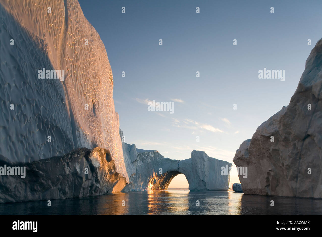 Greenland Ilulissat Setting midnight sun lights massive arched iceberg from Ilulissat Kangerlua