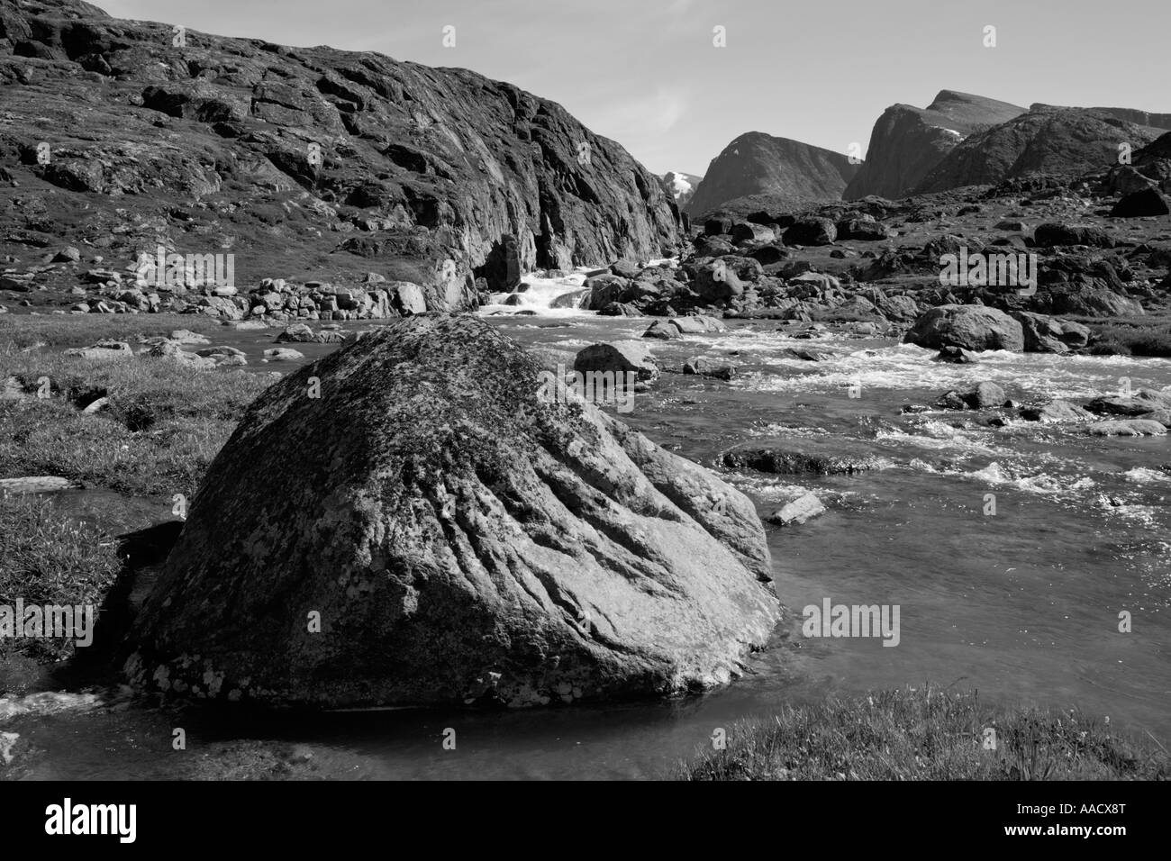 Greenland Itilleq Black and white image of morning sun mountain stream in hills above Anders Olsen Sound on summer day Stock Photo