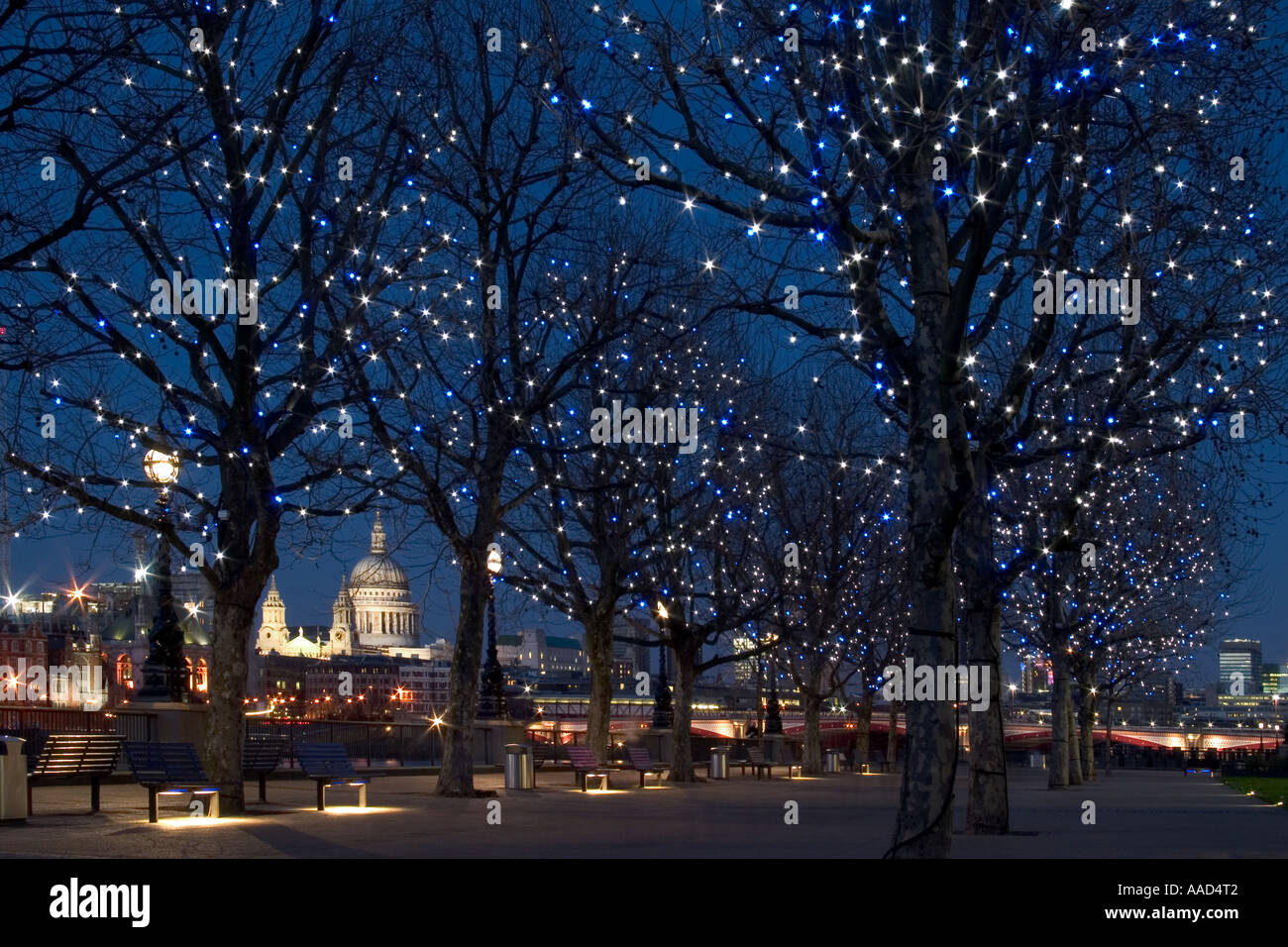 South Bank of River Thames at twilight with tree lights and St Paul's Cathedral in background. London, England Stock Photo