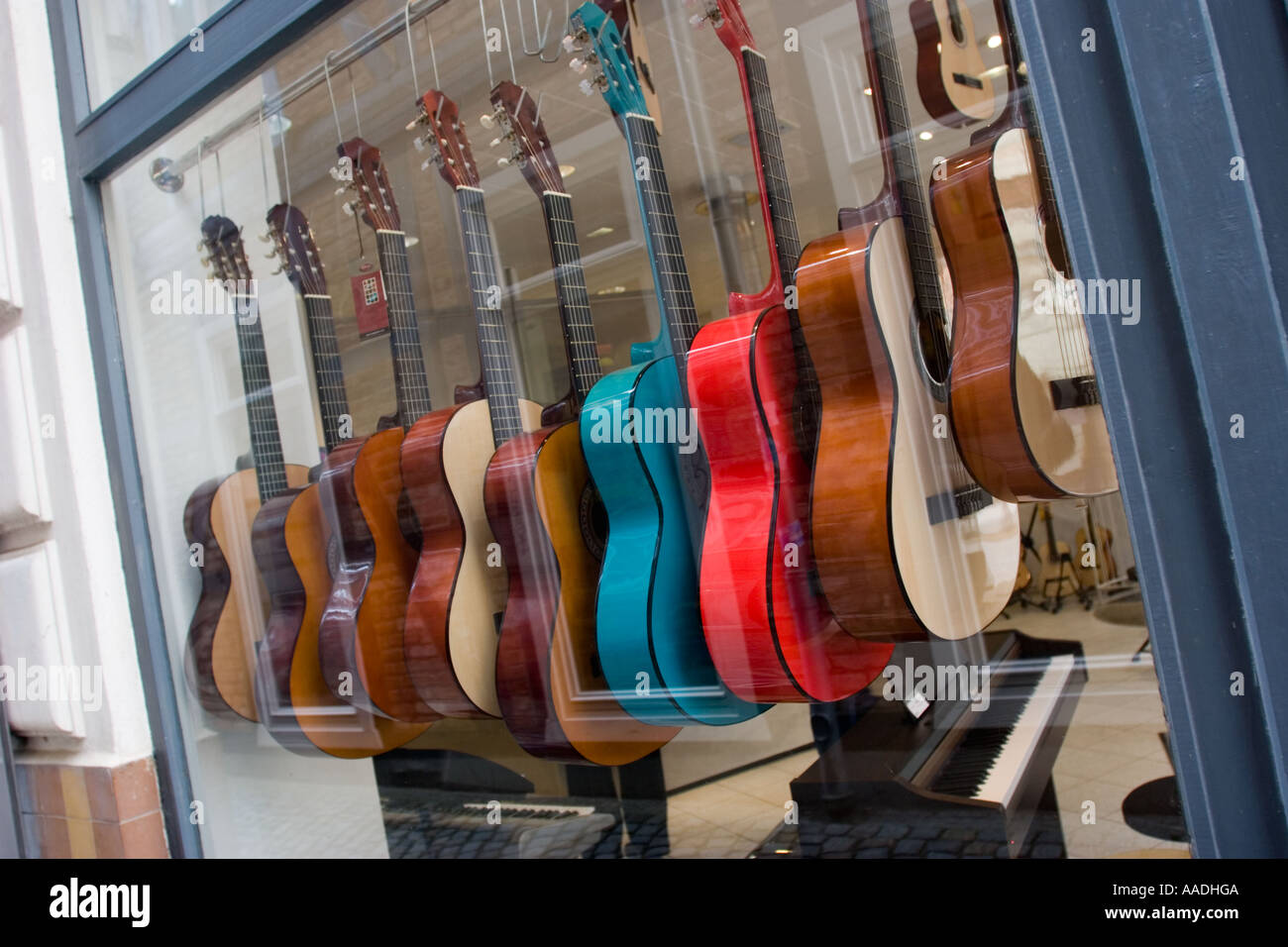 Row of Coloured  guitars in shop window, Schwerin, the capital of Mecklenburg-Vorpommern North Germany EU Stock Photo