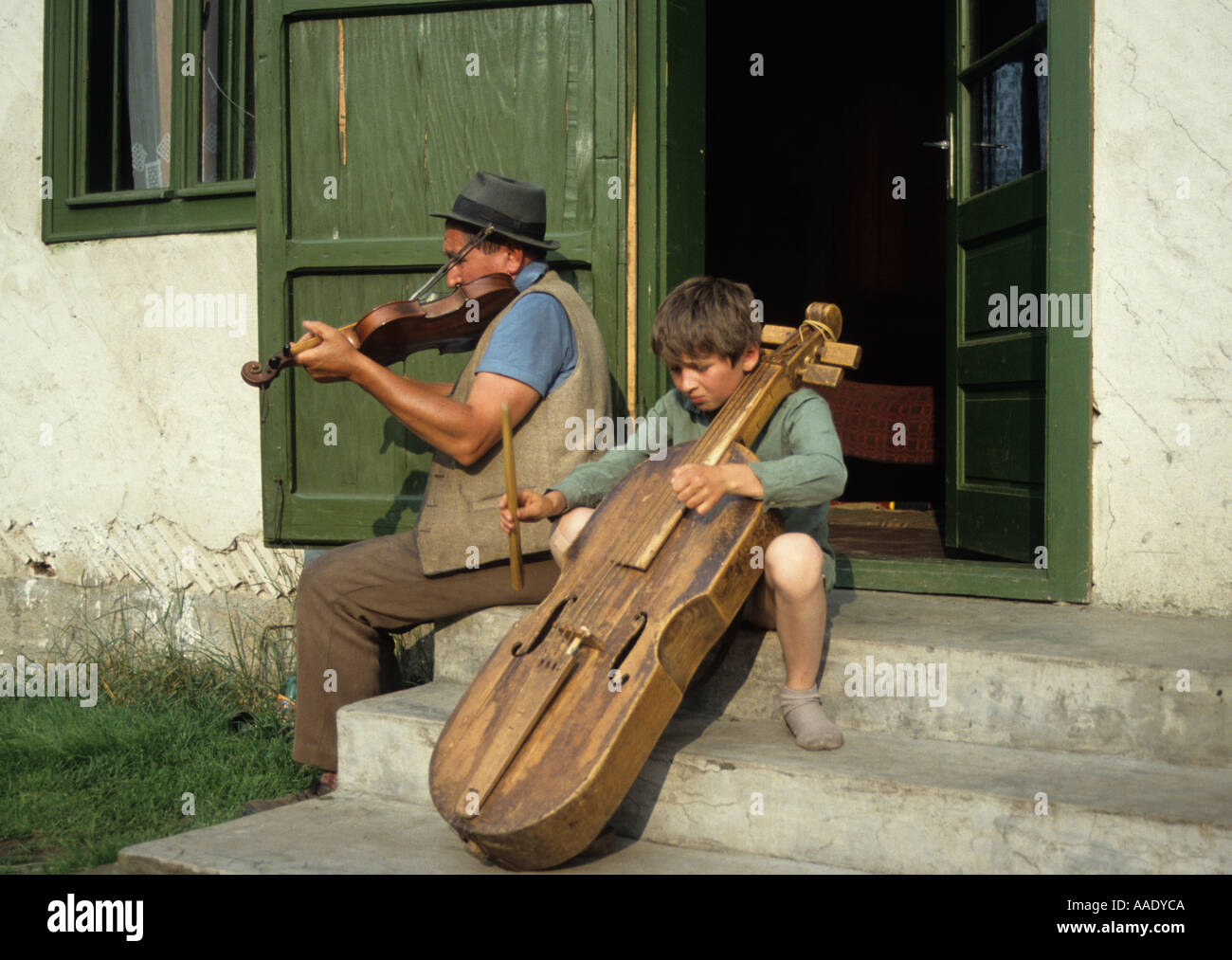 Hungarian ethnic Csango blind violin player and stepson playing gardon in Ghimes Transylvania Romania Stock Photo