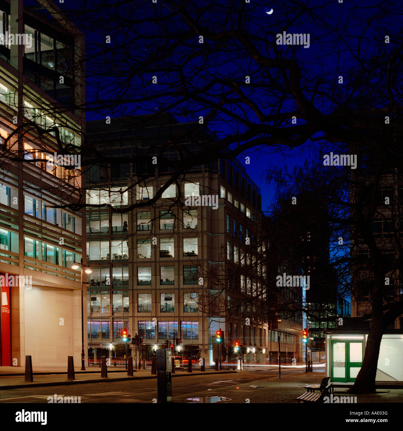 dusk shot of office blocks and traffic at Finsbury Square, London; inc. quarter moon, trees, traffic lights Stock Photo
