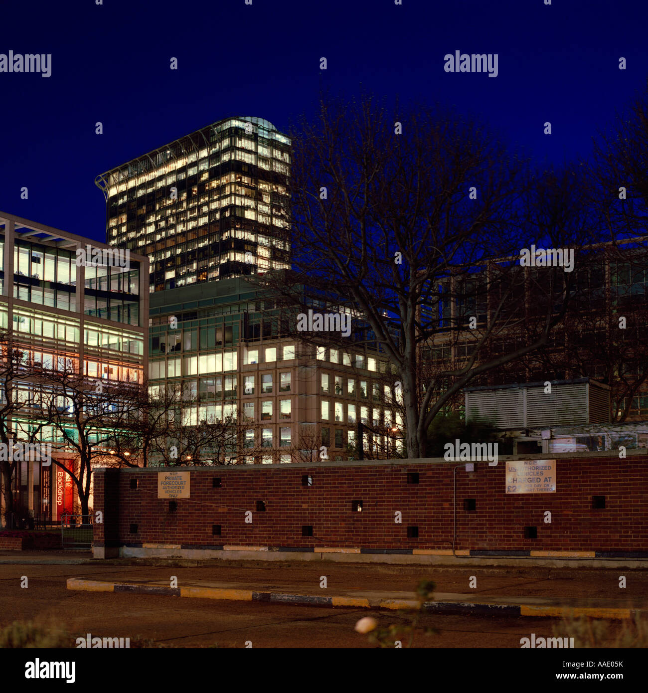 dusk shot of office blocks at Finsbury Square, London; inc. trees, NCP car-park, parking signs Stock Photo
