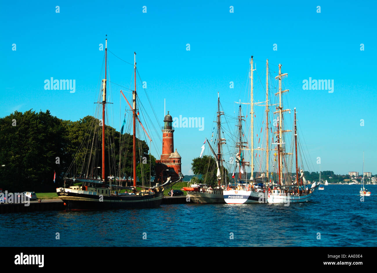 Boats moored near the lighthouse at the entrance to the Kiel Canal Kiel Holtenau Germany Stock Photo