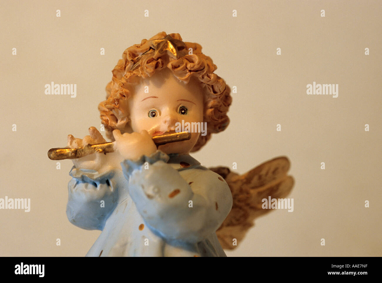 small angel playing flute Stock Photo