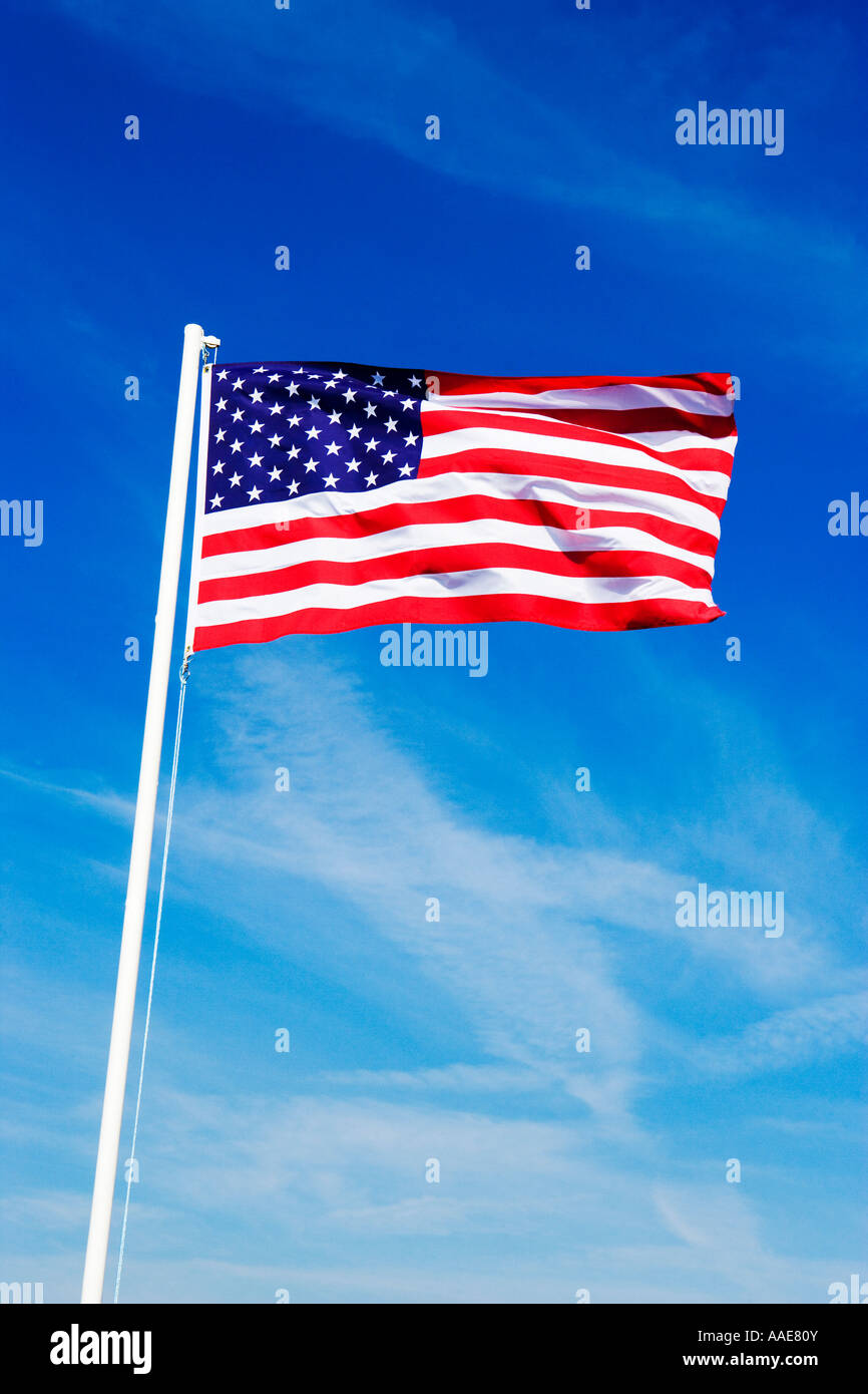 American flag fluttering on a white flag pole Stock Photo