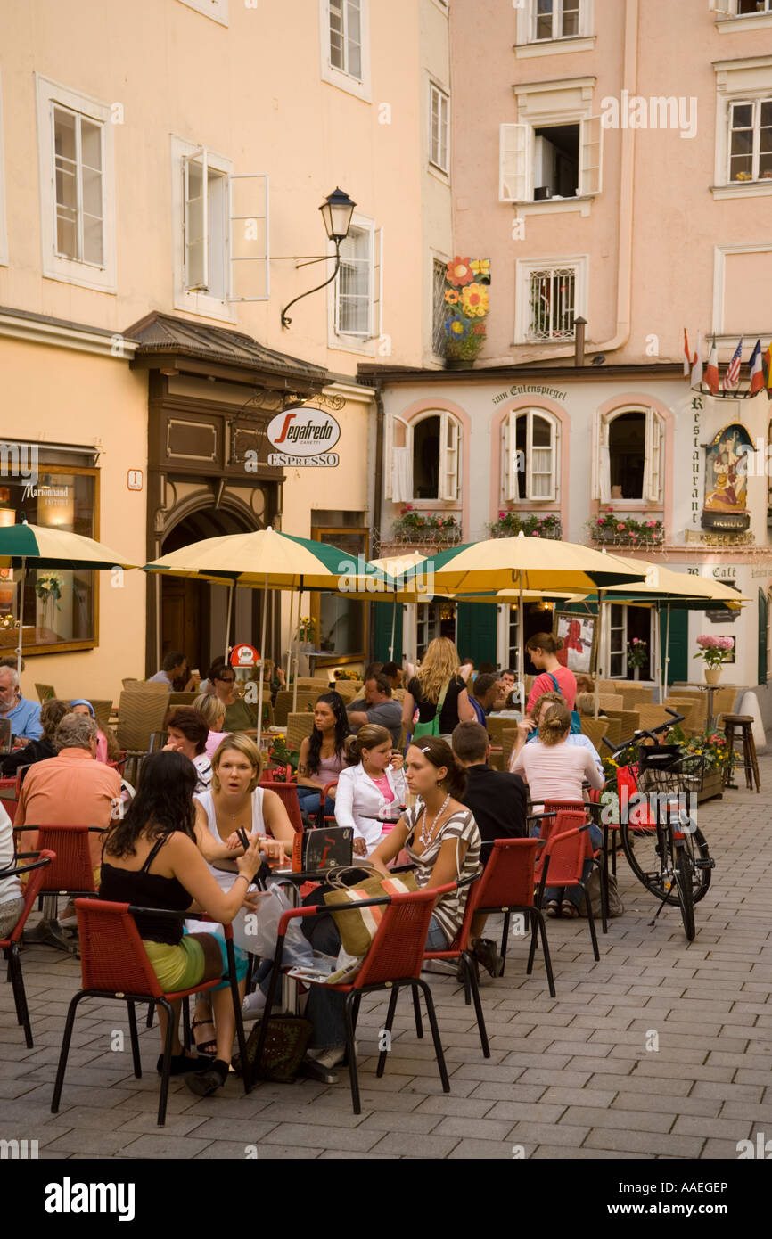 People sitting in a pavement cafe Zum Eulenspiegel at Hagenauer Square Salzburg Salzburg Austria Stock Photo