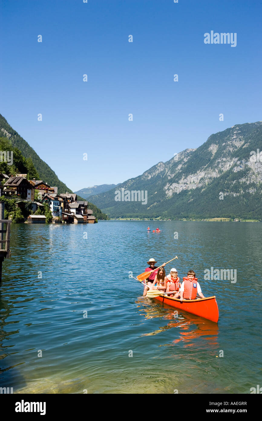 Children in a canoe lake Hallstatt Hallstatt Salzkammergut Upper Austria Austria Stock Photo