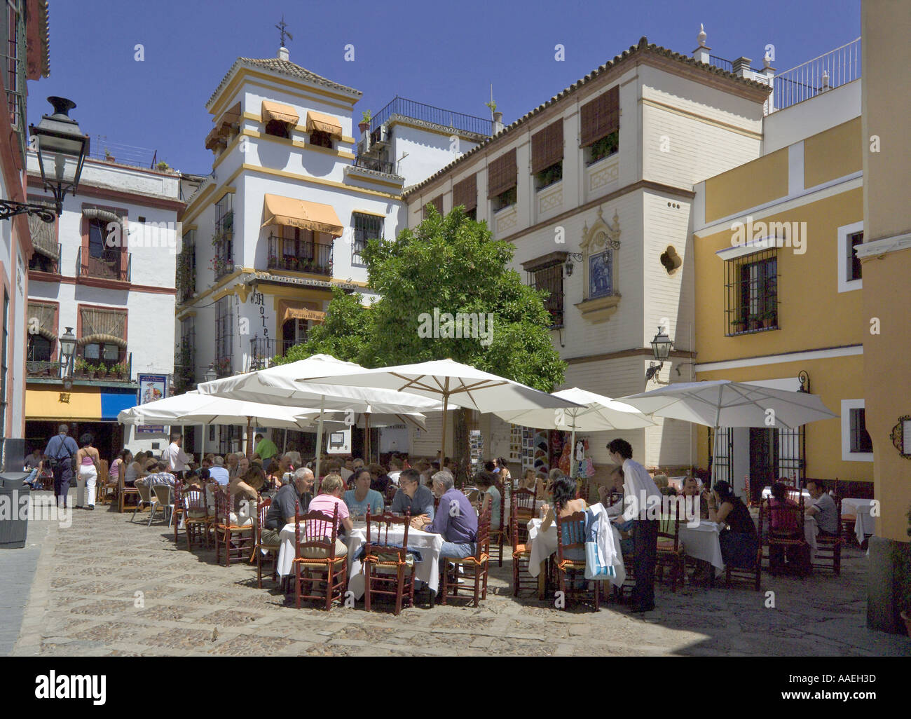 Seville Andalucia, Spain, street Restaurant at lunch, Plaza de los Venerables, Barrio Santa Cruz Stock Photo