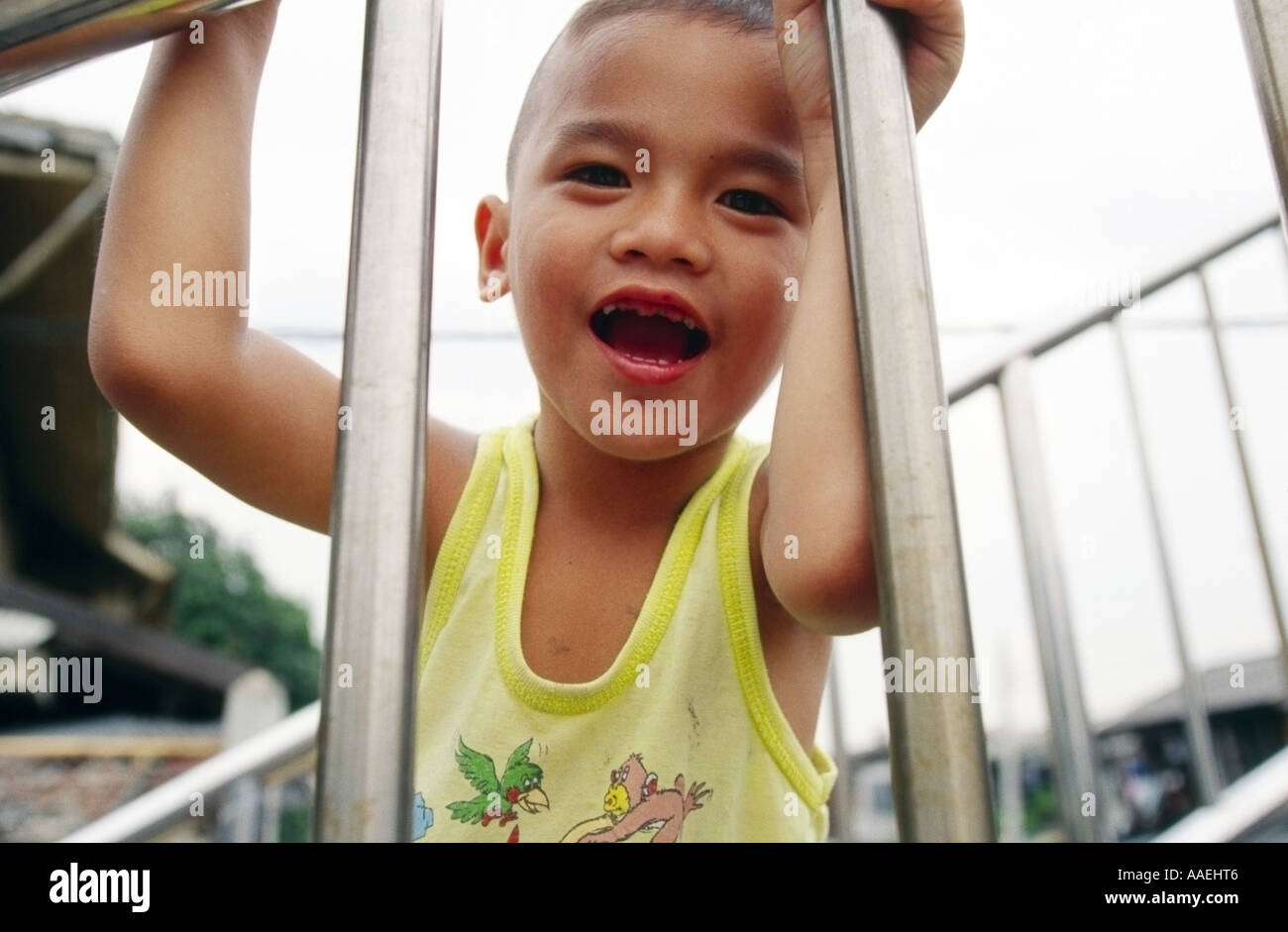 Thai boy smiling showing broken teeth Stock Photo