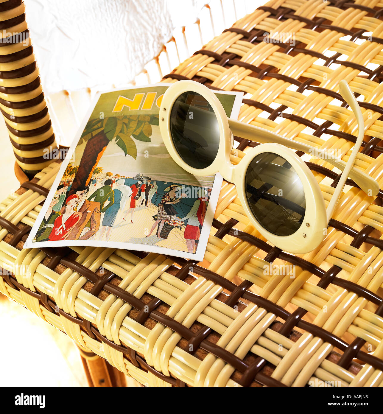 sunglasses and postcard on bistro chair Stock Photo