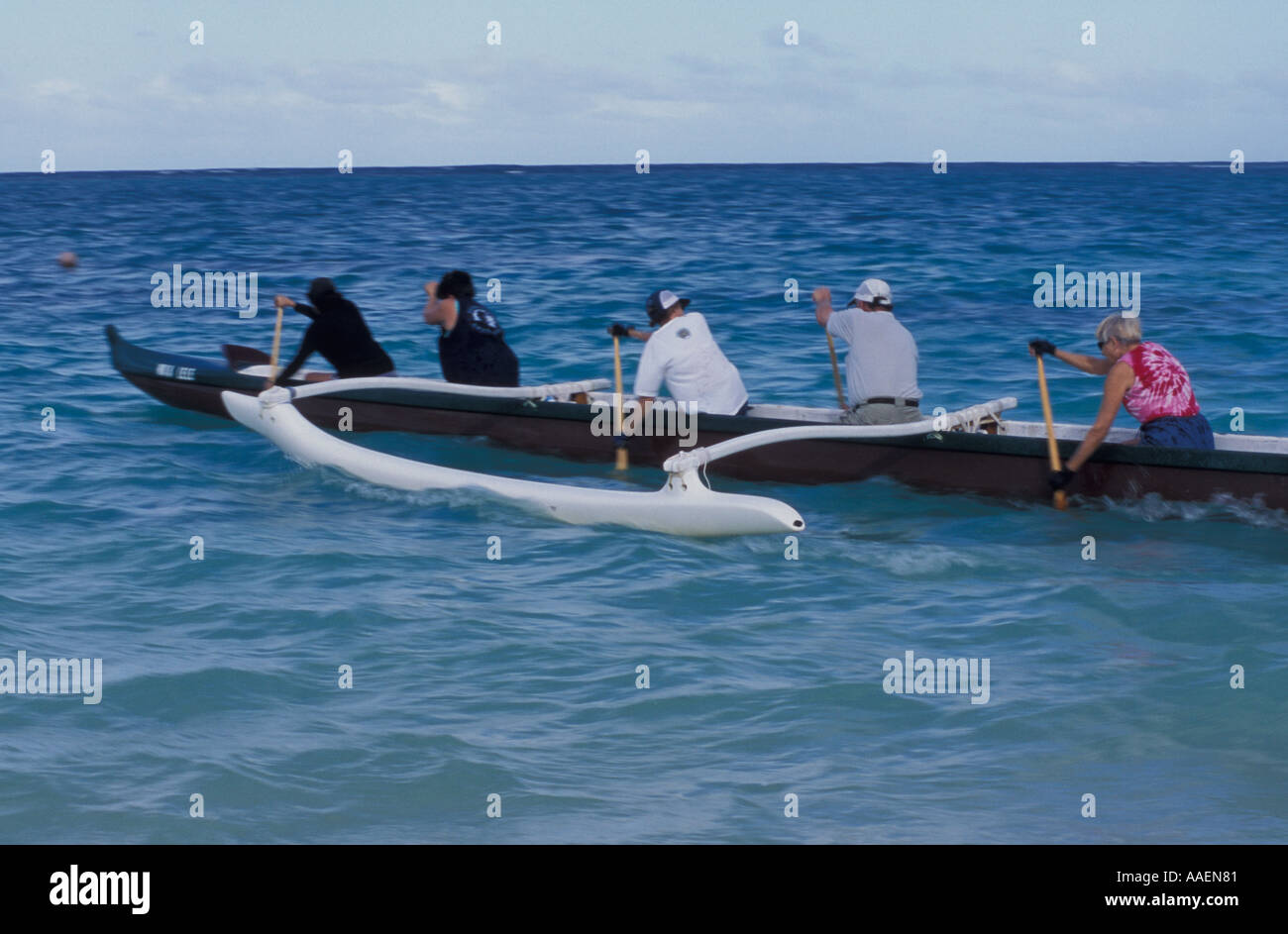 Picture/Photo: Young women padding a hawaiian outrigger canoe, Maunalua  Bay, late afternoon. Oahu island, Hawaii, USA