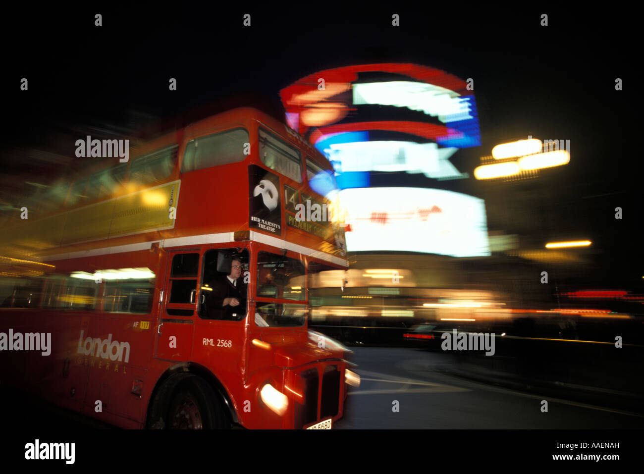 Double decker bus passing Piccadilly Circus at night London London England United Kingdom Stock Photo