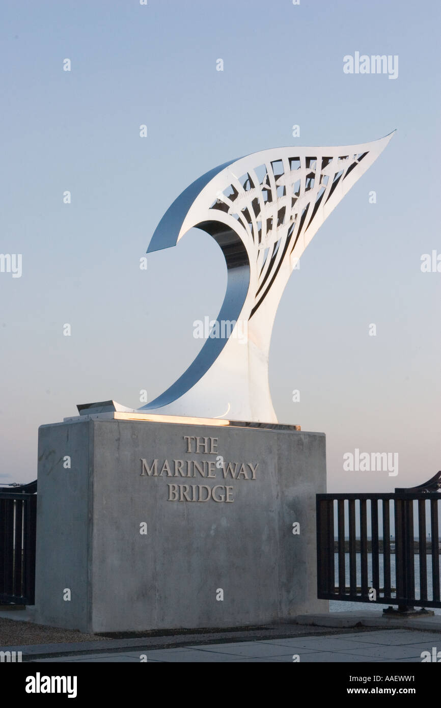 Dawn light on Iconic Design Stainless steel Wave feature on plinth Southport UK. Art and Artwork forming the Marine Way Bridge Sculpture, Merseyside. Stock Photo