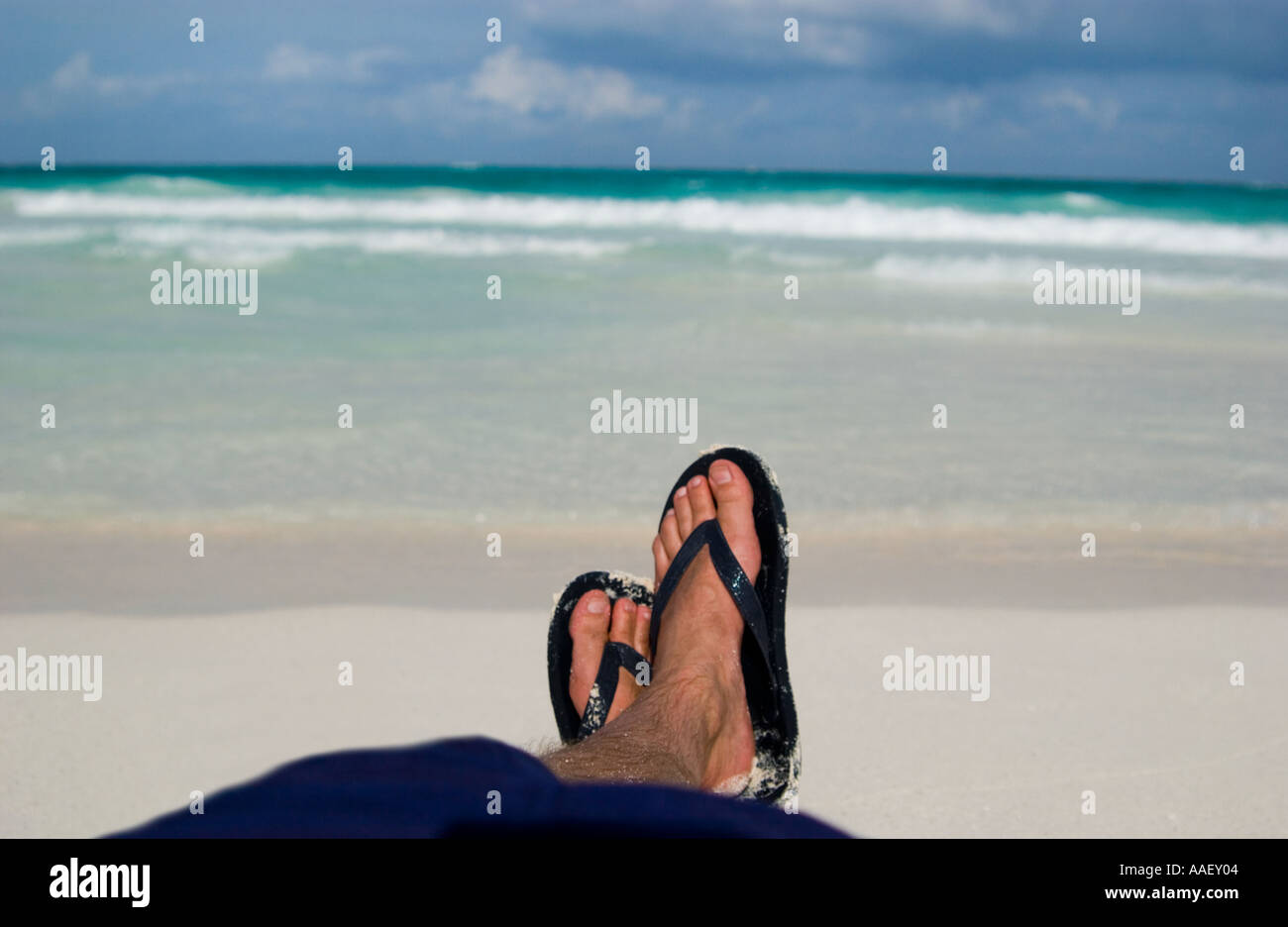 Mans feet on beach Stock Photo