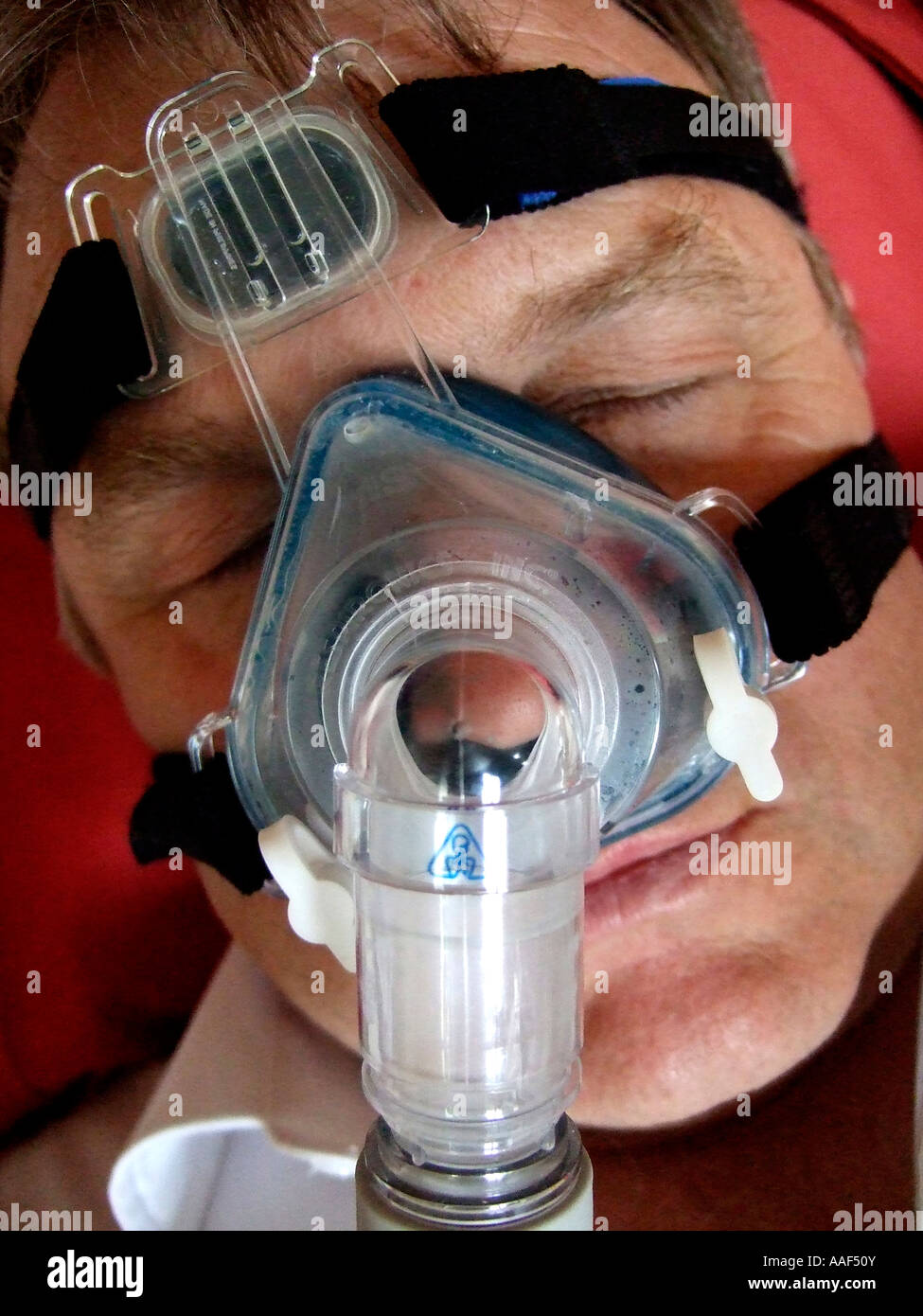 man wearing sleep apnoea mask Stock Photo Alamy