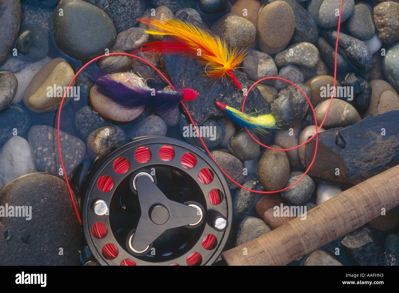 Fly Rode In Action Still Life of Fly rod colorful feathered flies laying on wet rocks ...