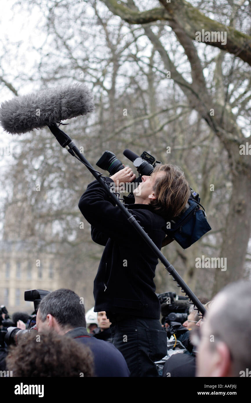 News camerman pointing his camera skyward during press coverage near The Houses of Parliament Westminster London Stock Photo