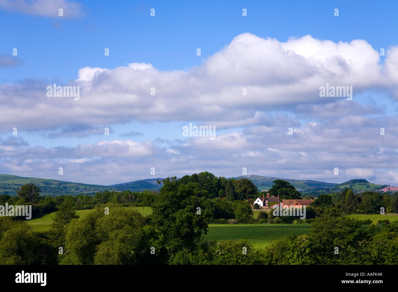 Farmhouse in wooded Shropshire hill country english countryside in