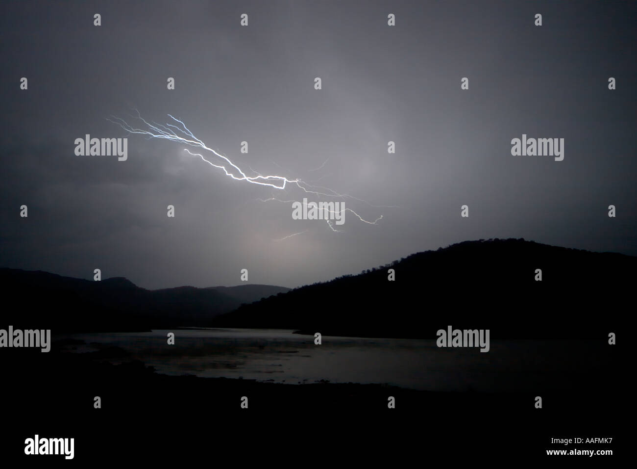 Lightning flashing between clouds over Blue Nile river mountains Stock Photo
