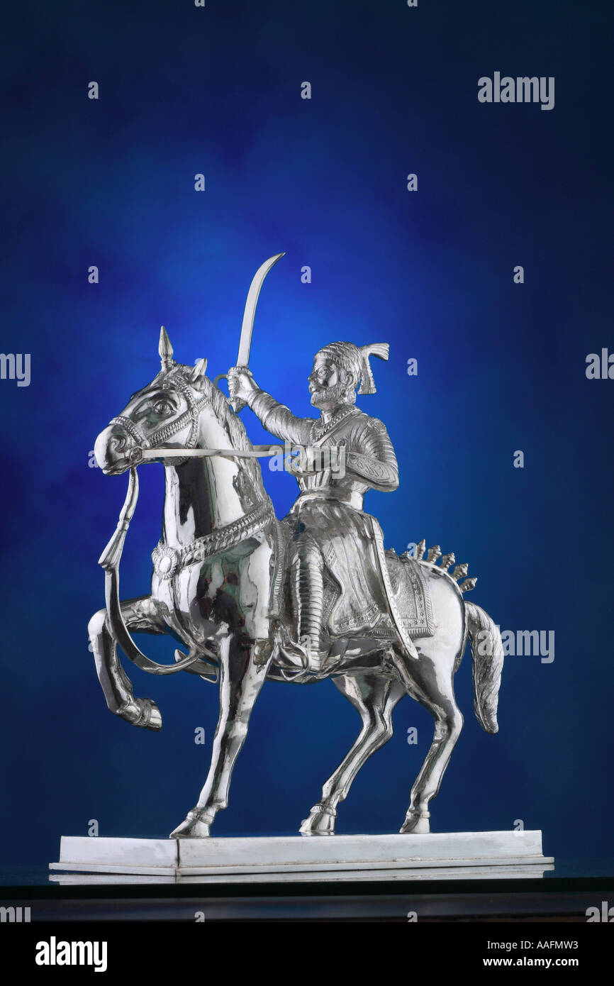 Chhatrapati Shivaji Maharaj, Chhatrapati Shivaji, silver statue, Maratha King, Maratha warrior, on horse with sword on blue background India Asia Stock Photo