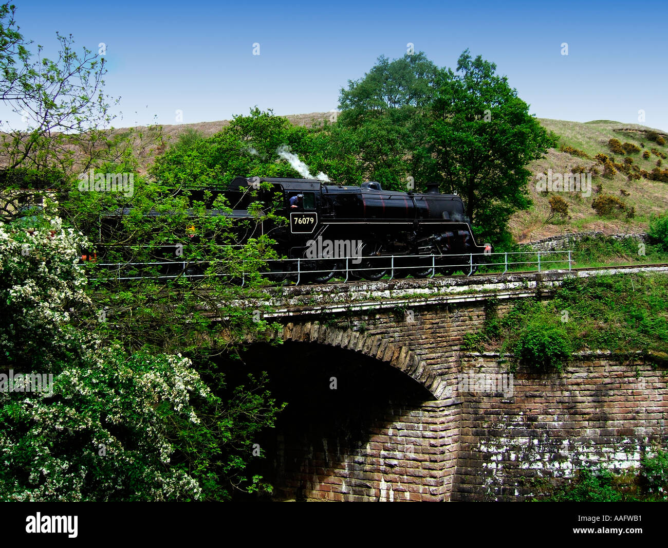 The North Yorkshire Moors Railway steam train crossing bridge near Gothland Stock Photo