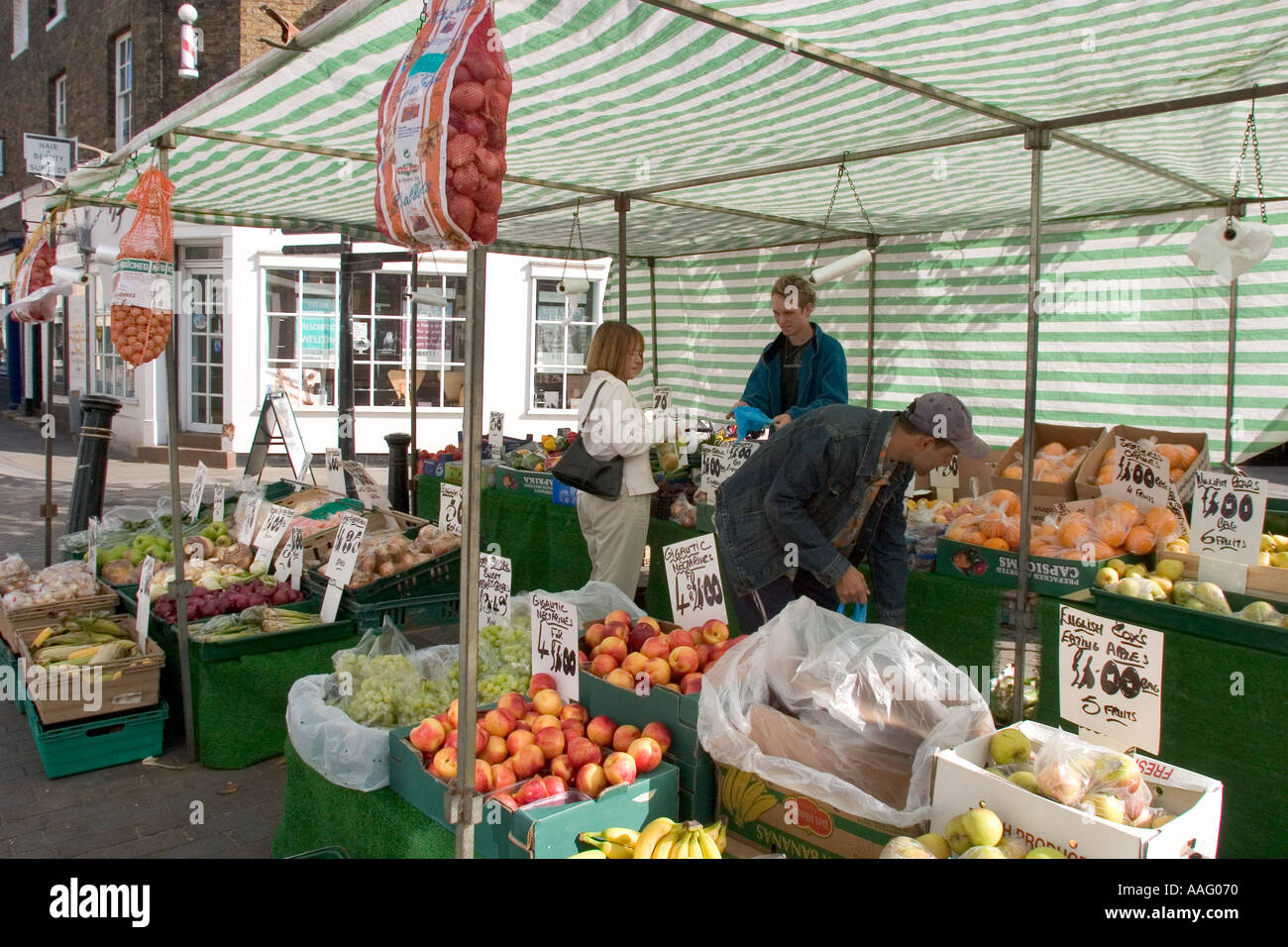 Shoppers at Market stall in town centre Hertford Hertfordshire GB UK Stock Photo