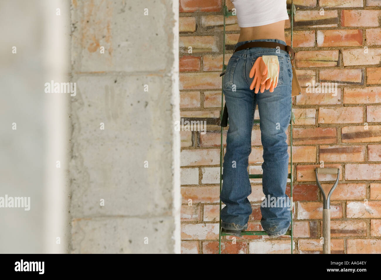 Female construction worker on ladder Stock Photo