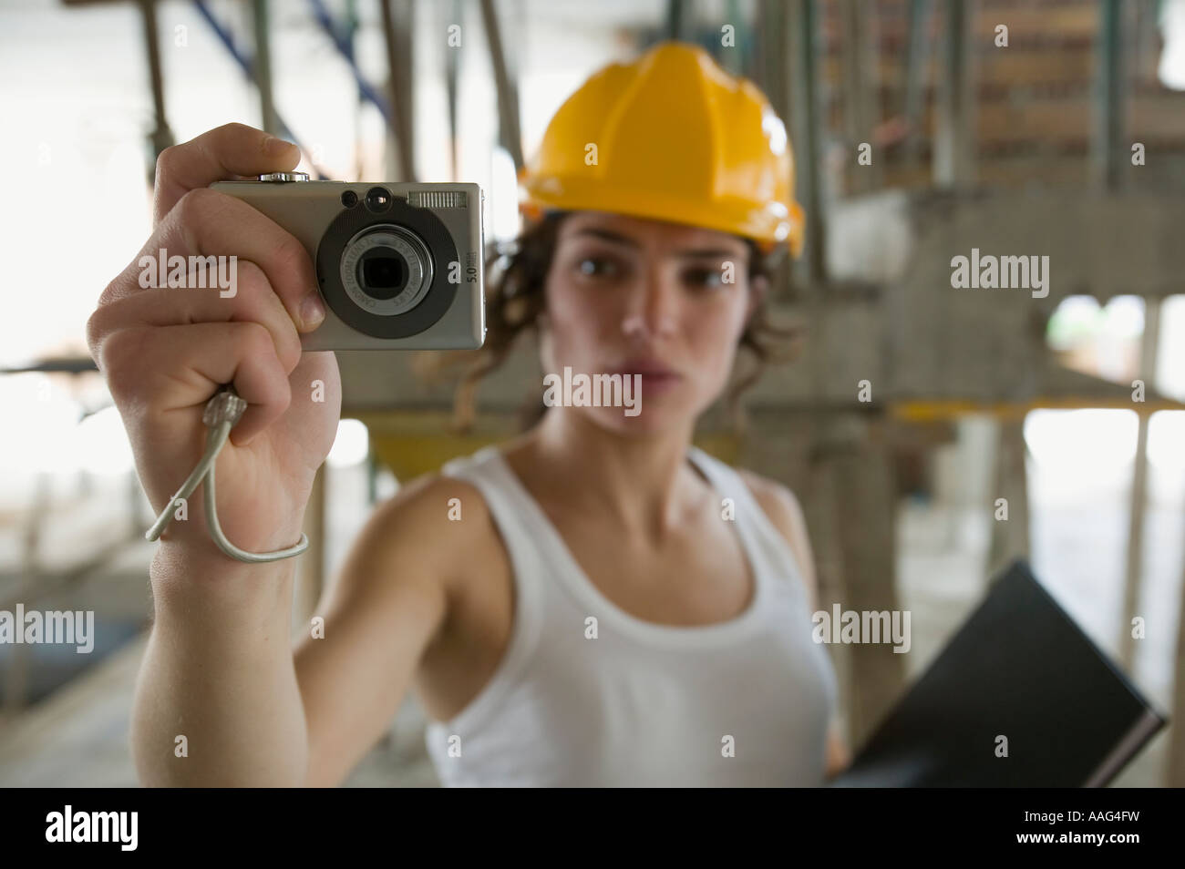 Female civil engineering surveyor using compact digital camera Stock