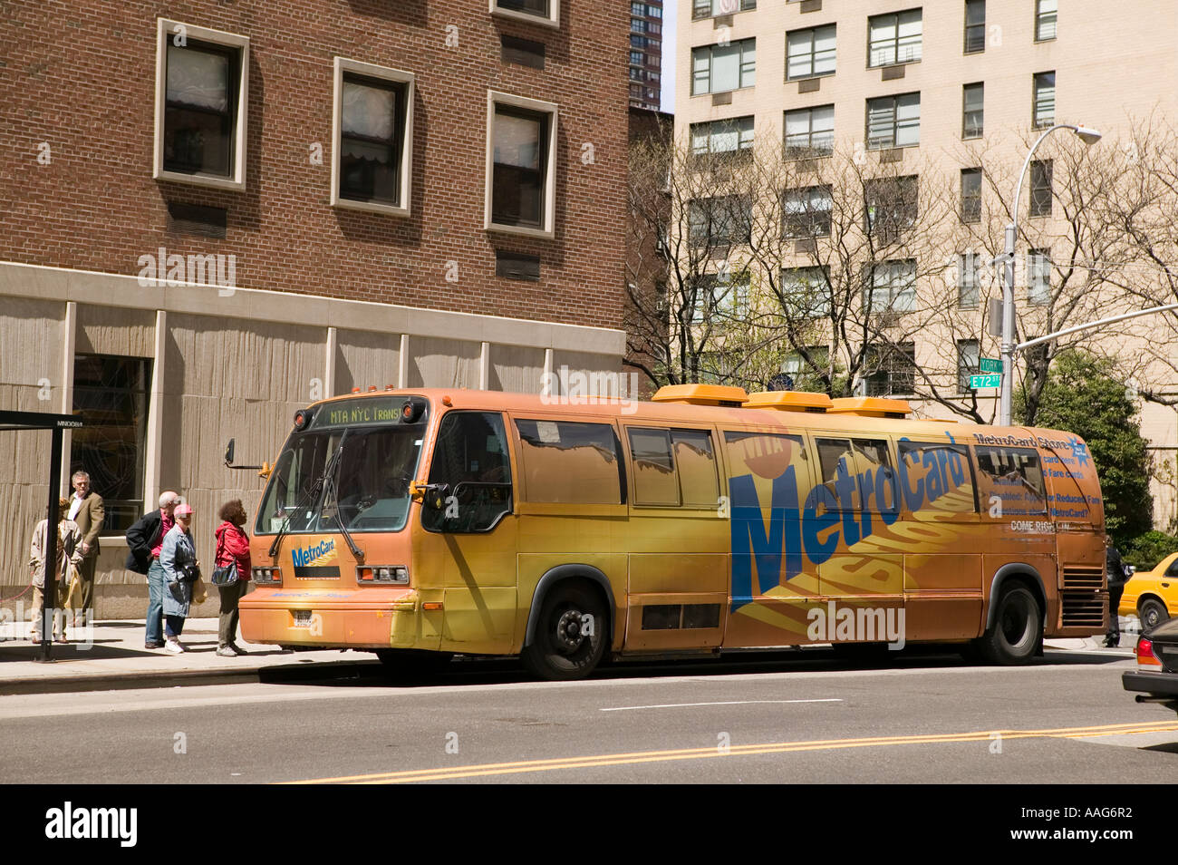 People wait to enter a Metrocard bus in a street in New York City USA April 2006 Stock Photo