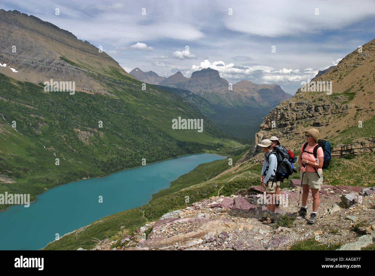 Hikers look out over Gunsight Lake in Glacier National Park Montana