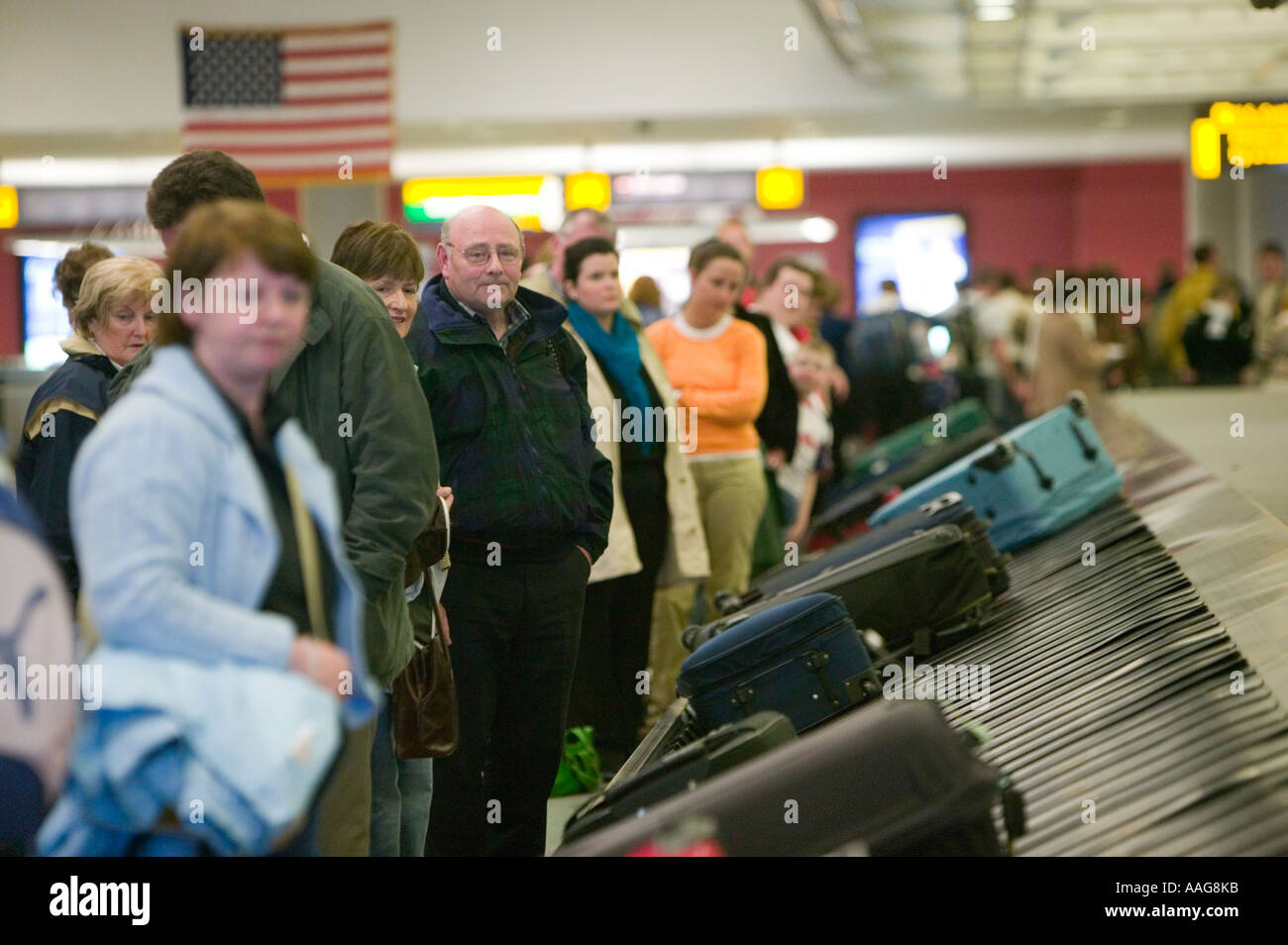 Passengers wait baggage carousel luggage hires stock photography and