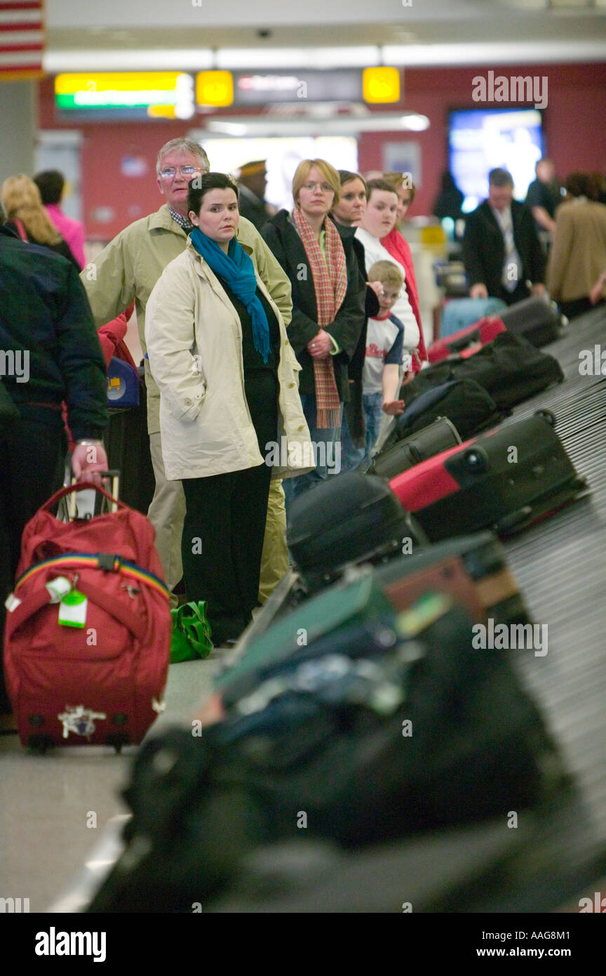 Passengers wait baggage carousel luggage hires stock photography and