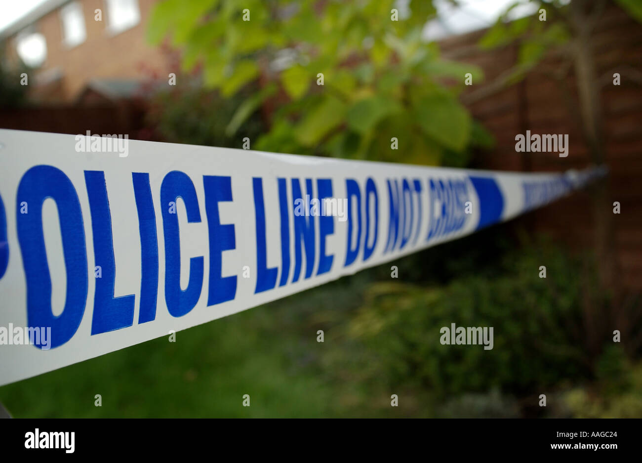 blue and white police tape cordoning off a crime scene Stock Photo Alamy