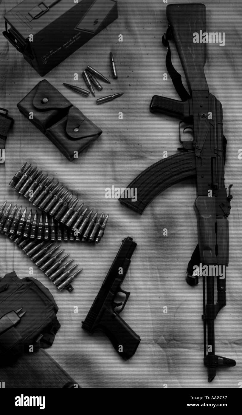 AK47 Kalashnikov rifle with a glock 17L gun ammunition and parts of webbing uniform Stock Photo