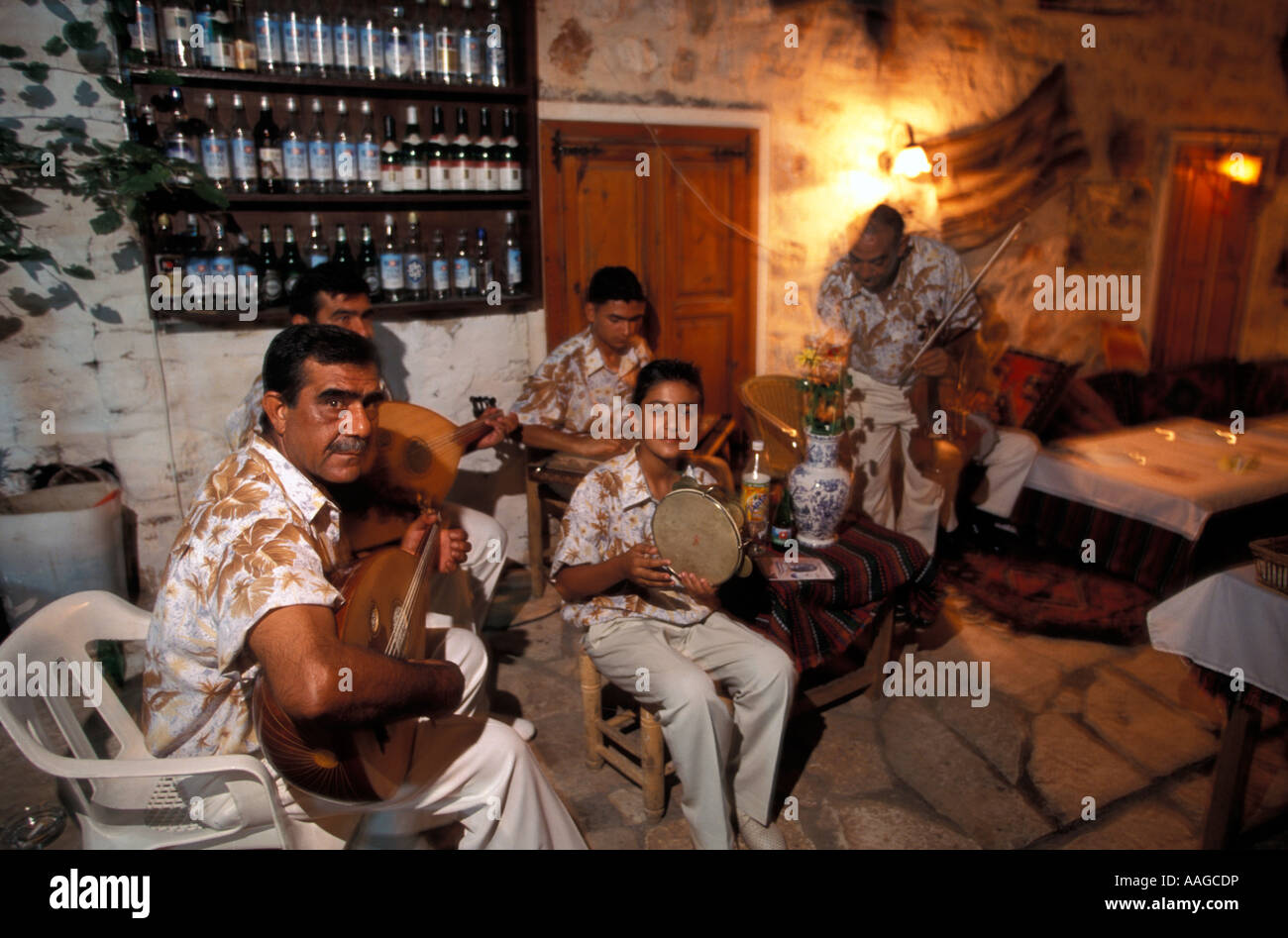Men playing traditional music folk music in a restaurant Kalkan Mugla Lycian Coast Turkey Stock Photo