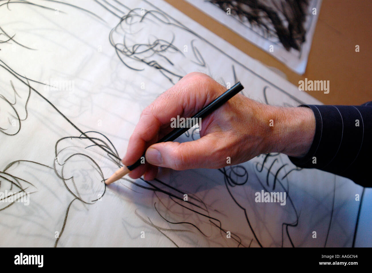 An artist draws on paper Stock Photo Alamy