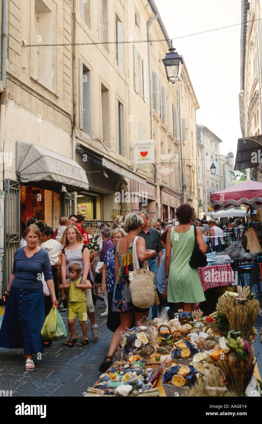 FRANCE Uzes Shoppers crowd narrow street on market day dried flower