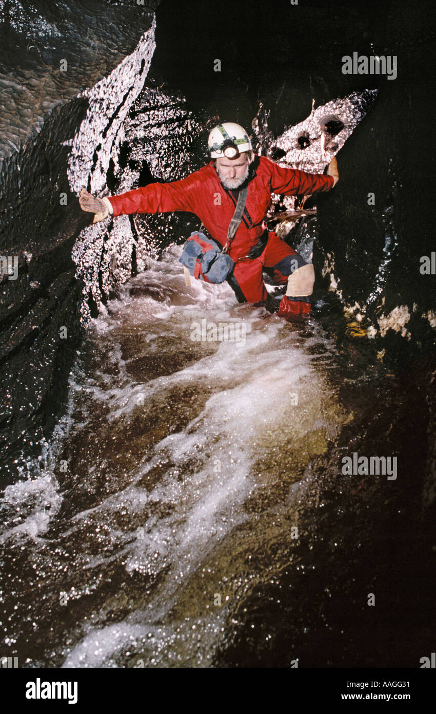 Caver in underground streamway Wales UK Stock Photo