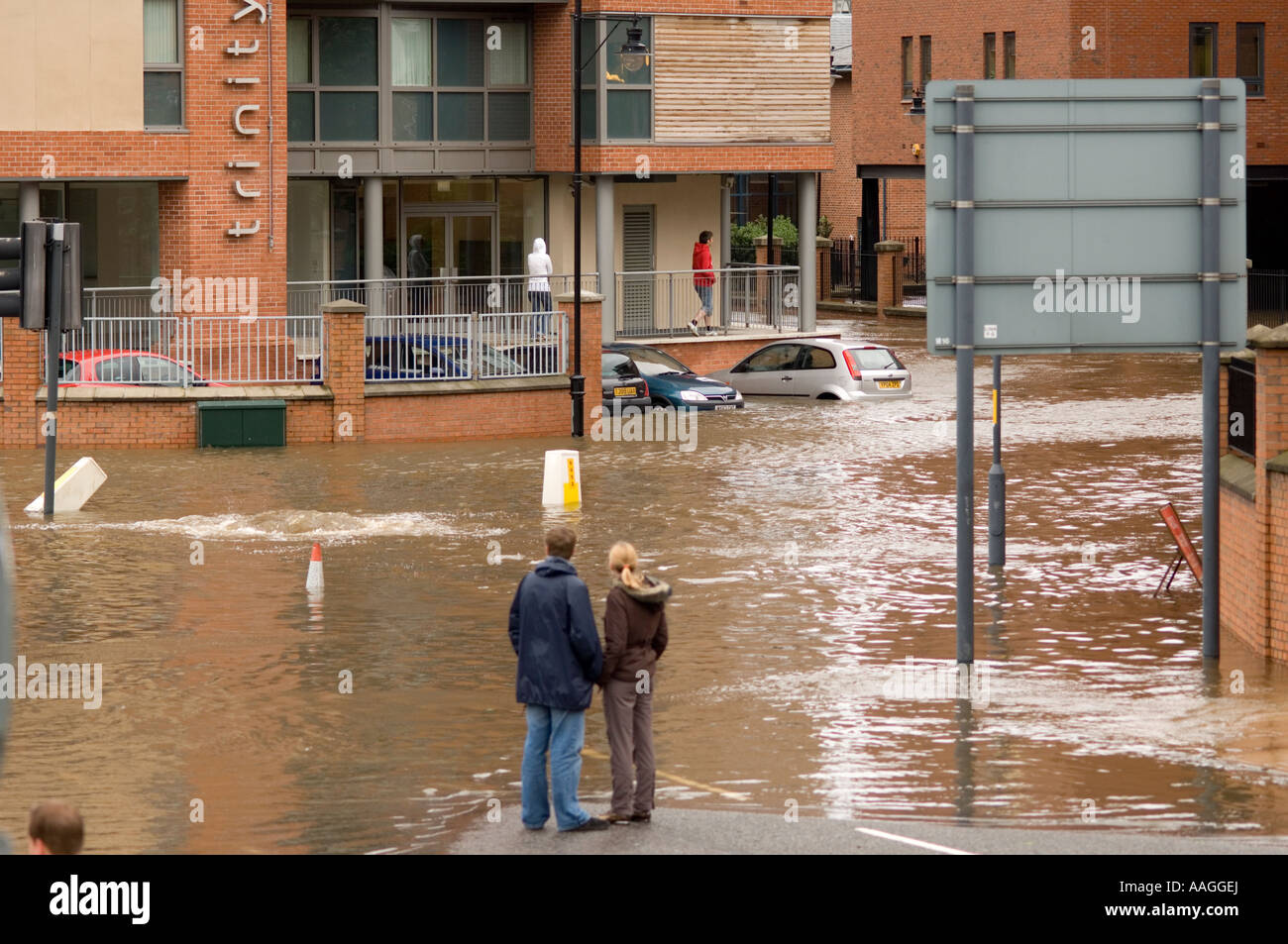 Flooded River Aire onlookers at Neptune Street & East Street Leeds with ...