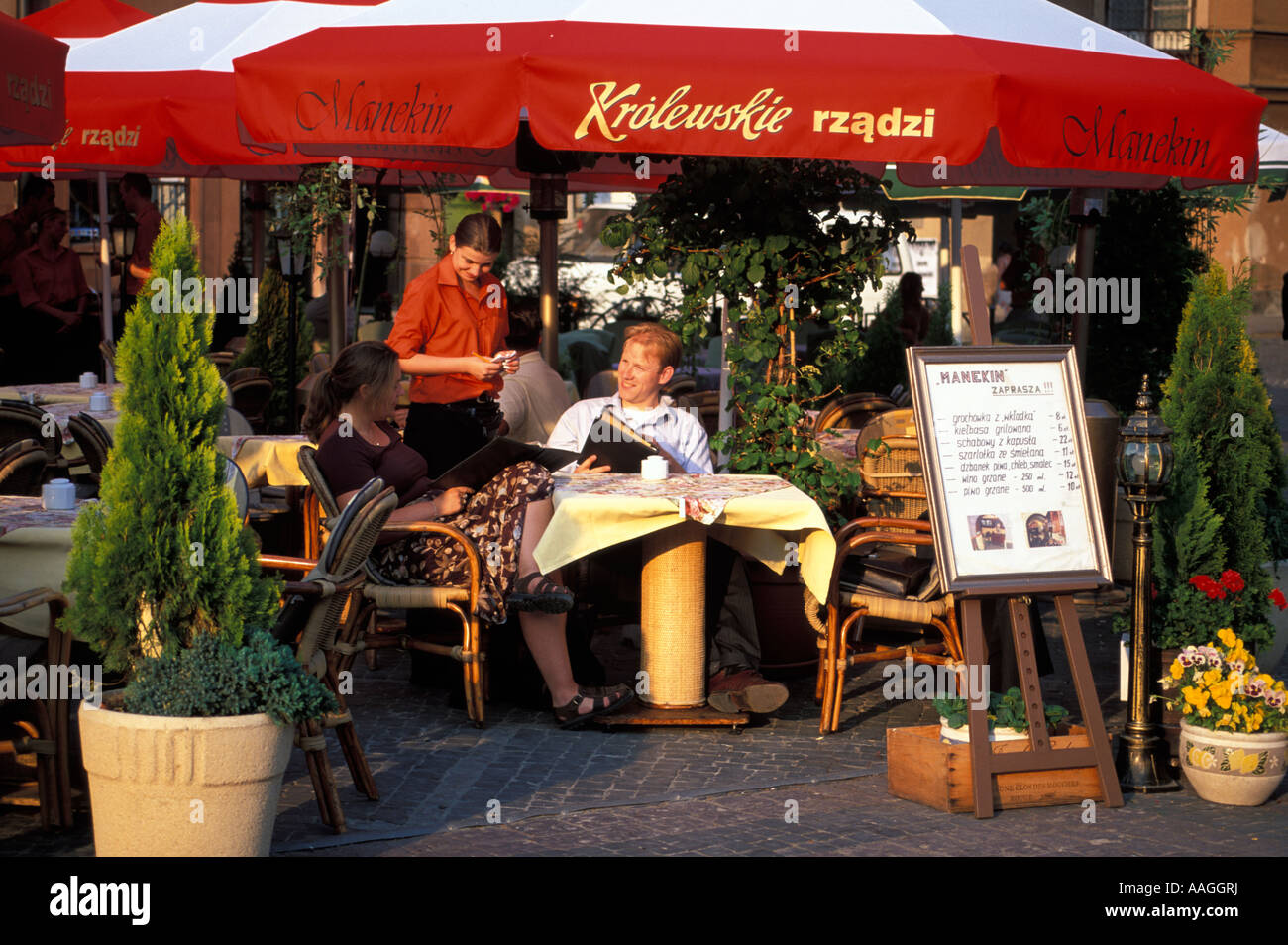 Couple sitting in a pavement cafe Old Town Market Warsaw Masovian Poland Stock Photo