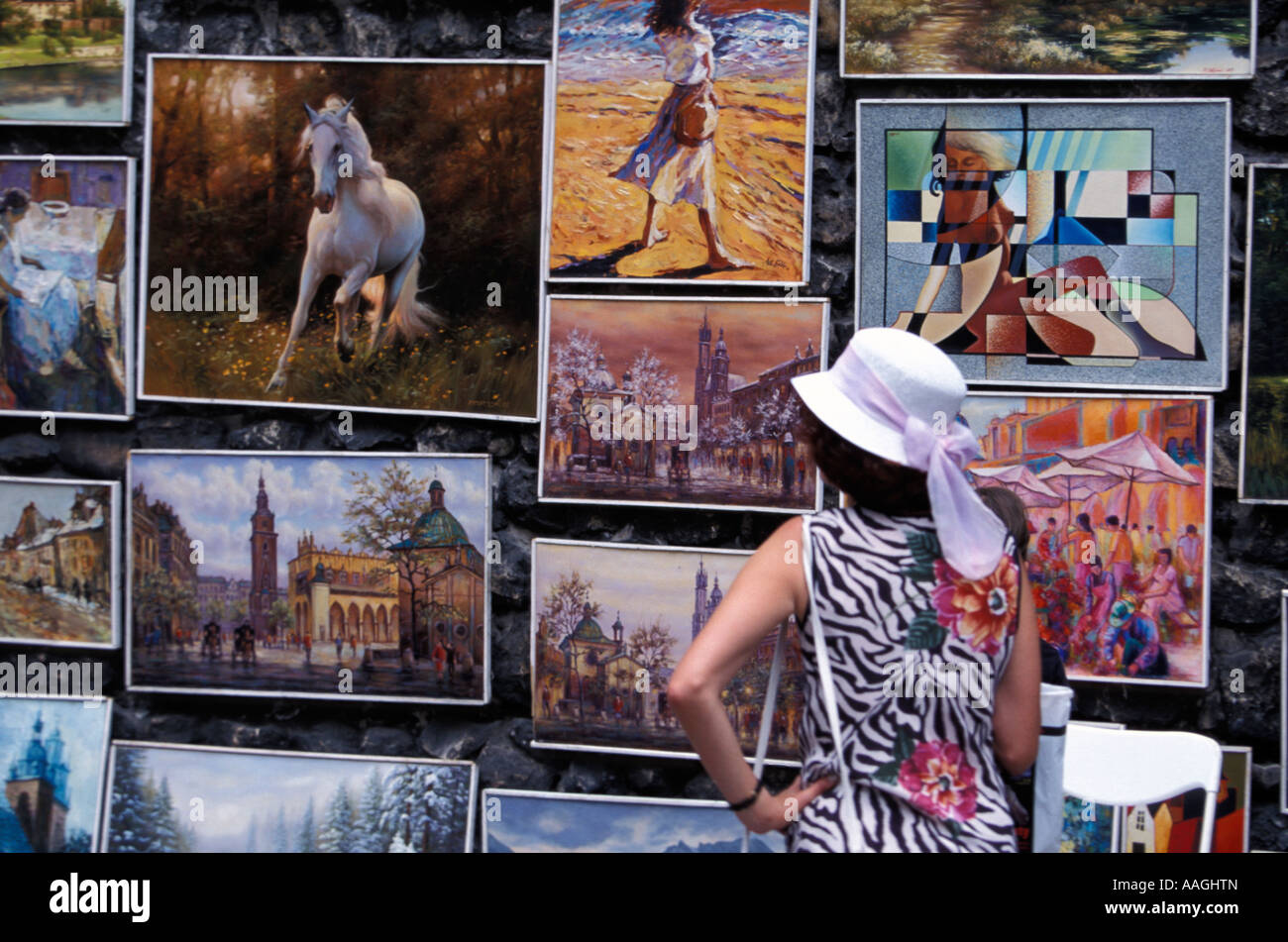 Woman looking at pictures open air gallery Florian s Gate City Wall Cracow Lesser Poland Poland Stock Photo