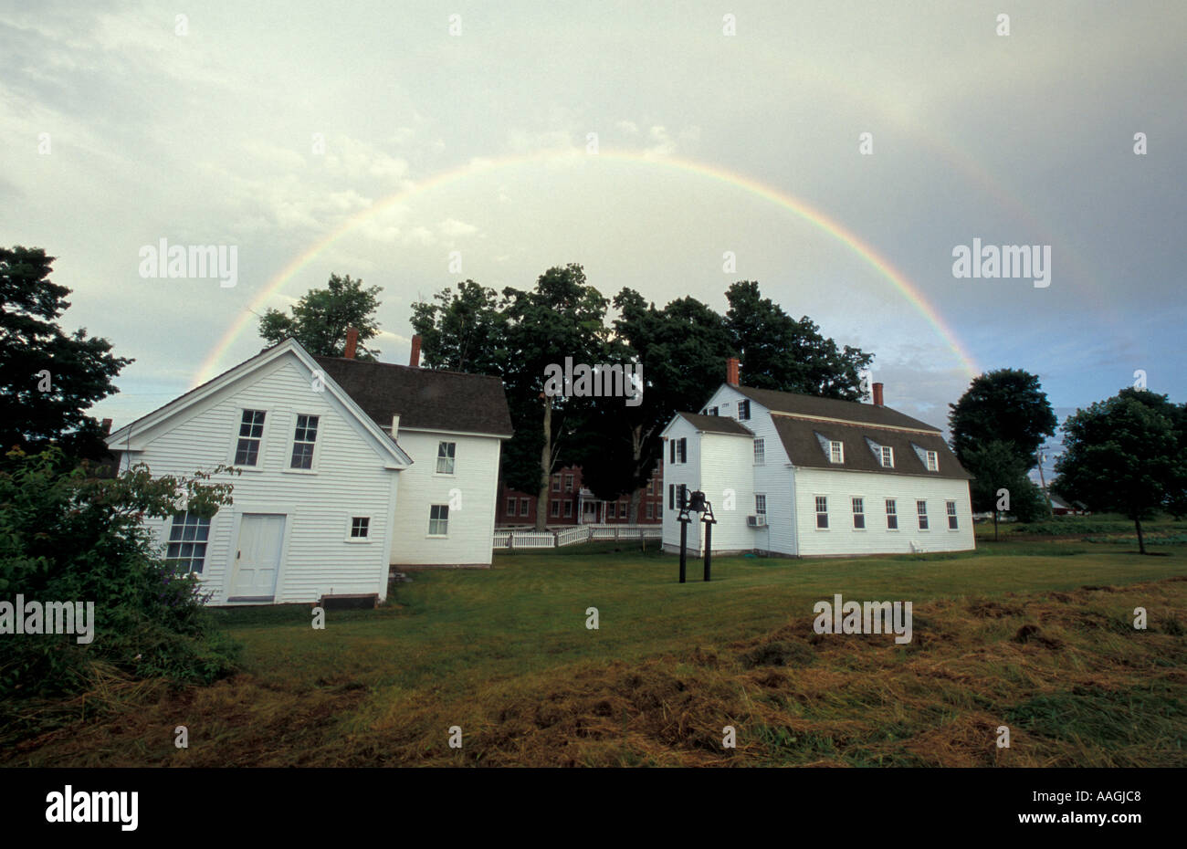 New Gloucester ME A rainbow arcs over the Ministry House and Meetinghouse right at the Sabbathday Lake Shaker Village  Stock Photo