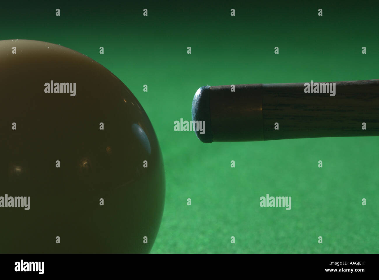 Cue ball and tip on the green baize of a snooker table UK Stock Photo