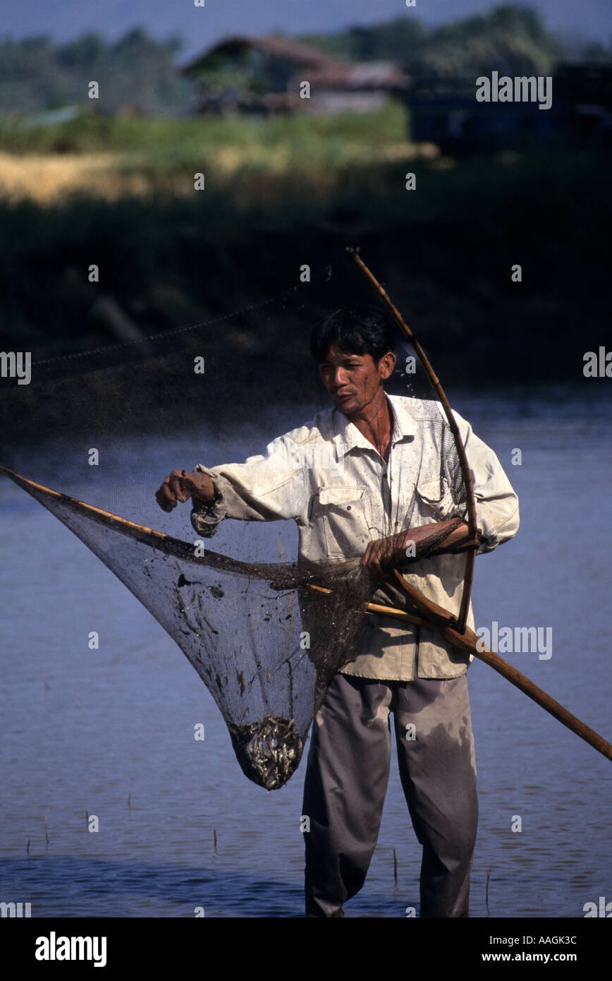 Thailand Chaing Mai Man fishing in field drainage ditches. Stock Photo