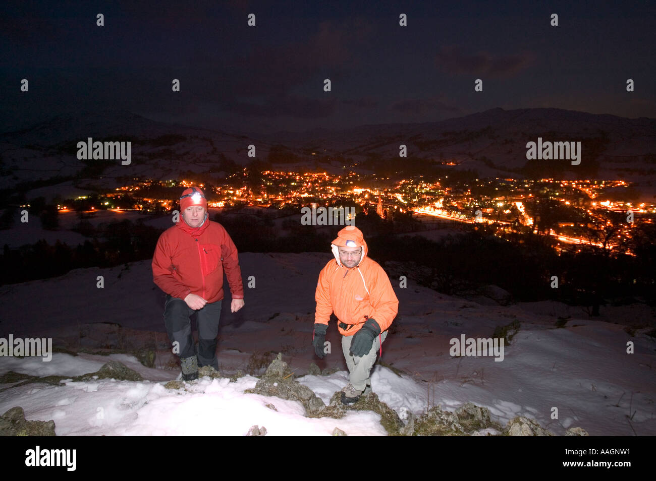 climbers in winter above Ambleside on a snowy night, Lake district, Cumbria, UK Stock Photo